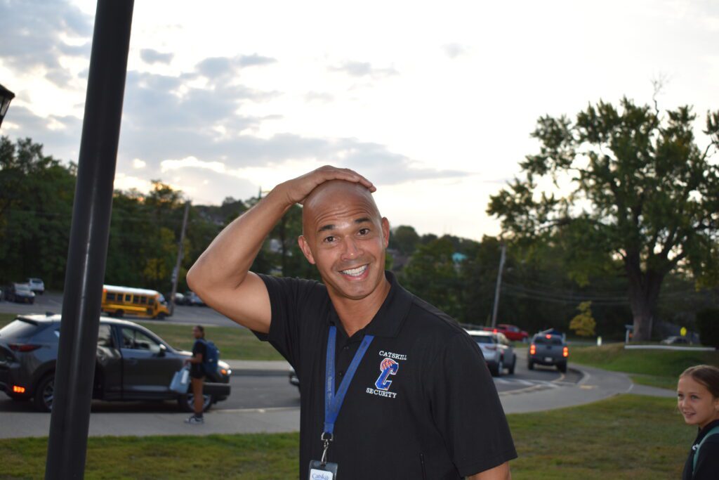 man with hand on his bald head
