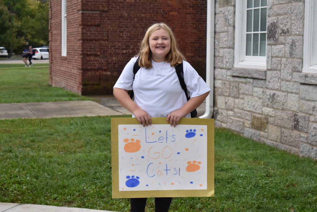girl holding sign