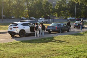 students getting out of car.