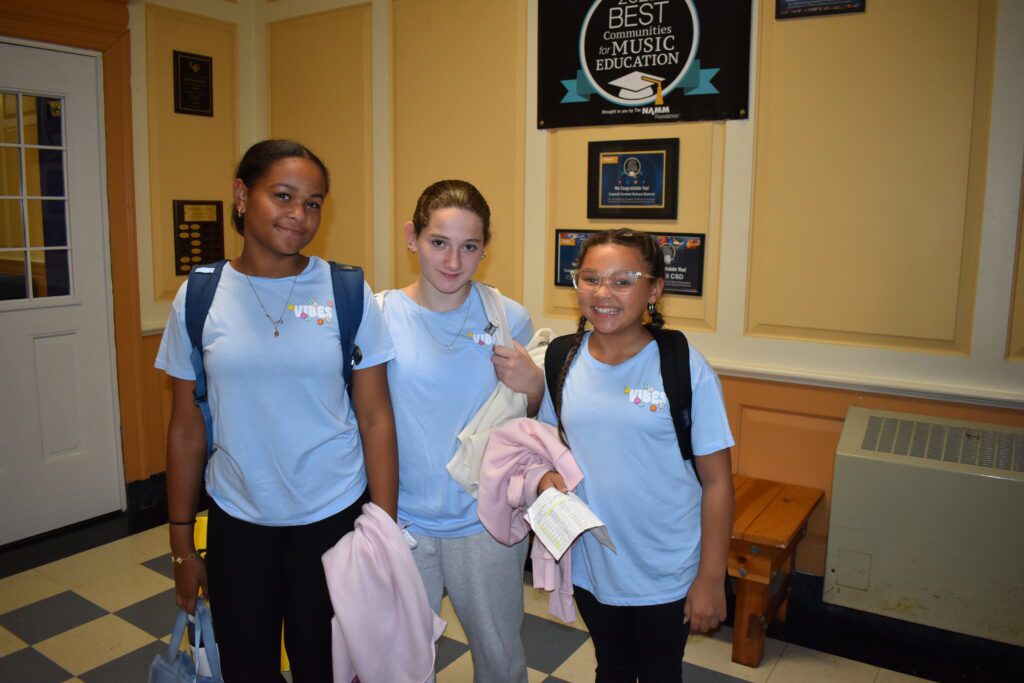 three girls wearing the same shirt