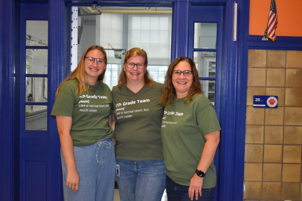 three women wearing the same shirt