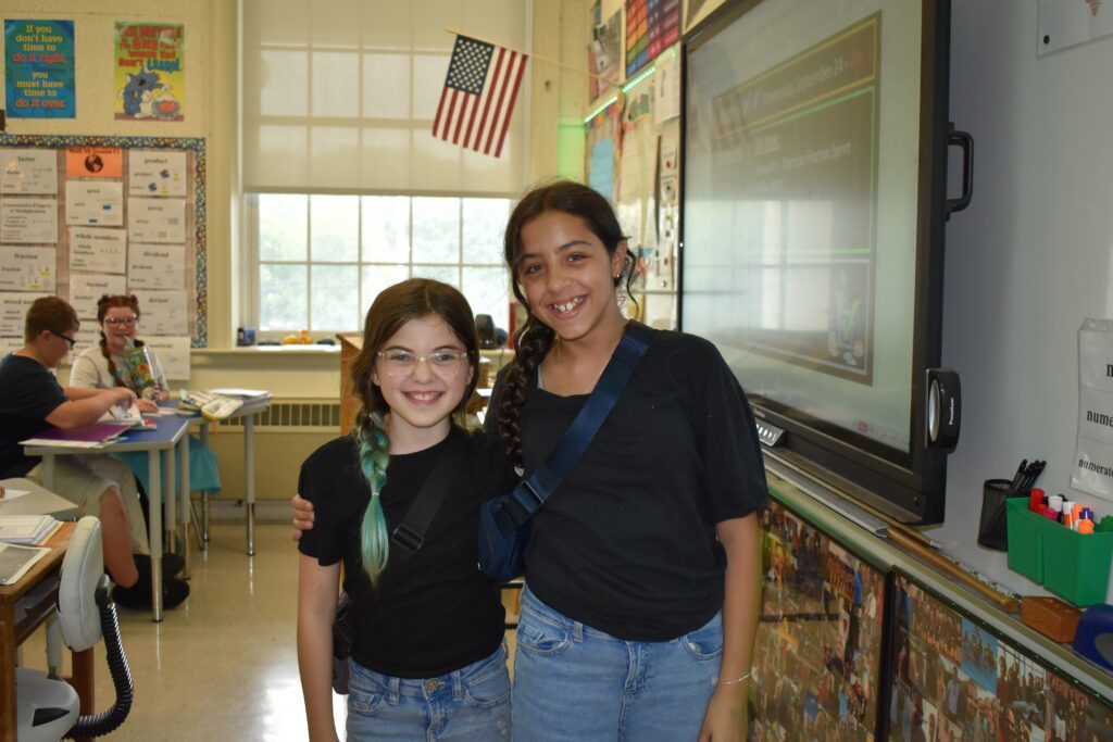 two girls wearing the same shirt
