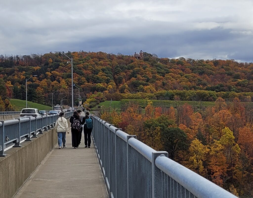 students walking across bridge.