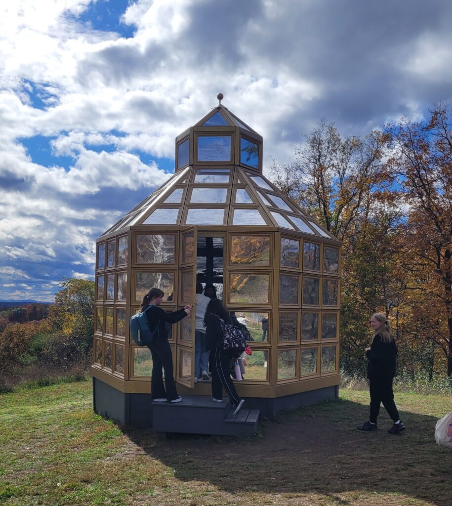 student standing next to gazebo art exhibit