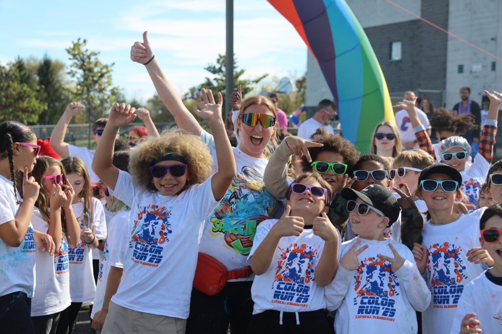crowd of students and teachers cheering