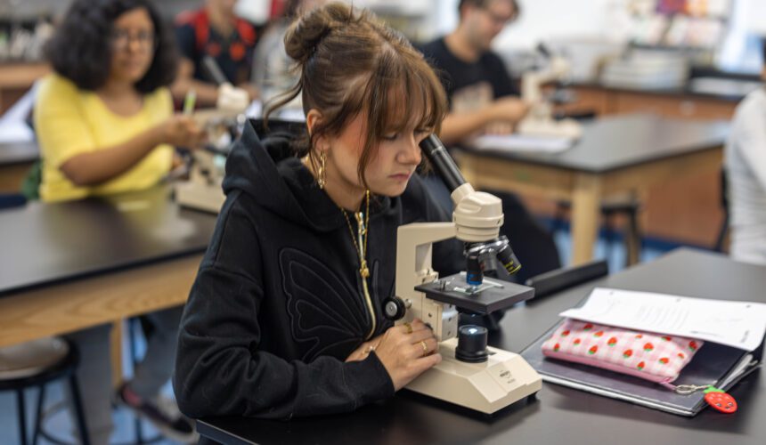 CHS-6 student looking through microscope