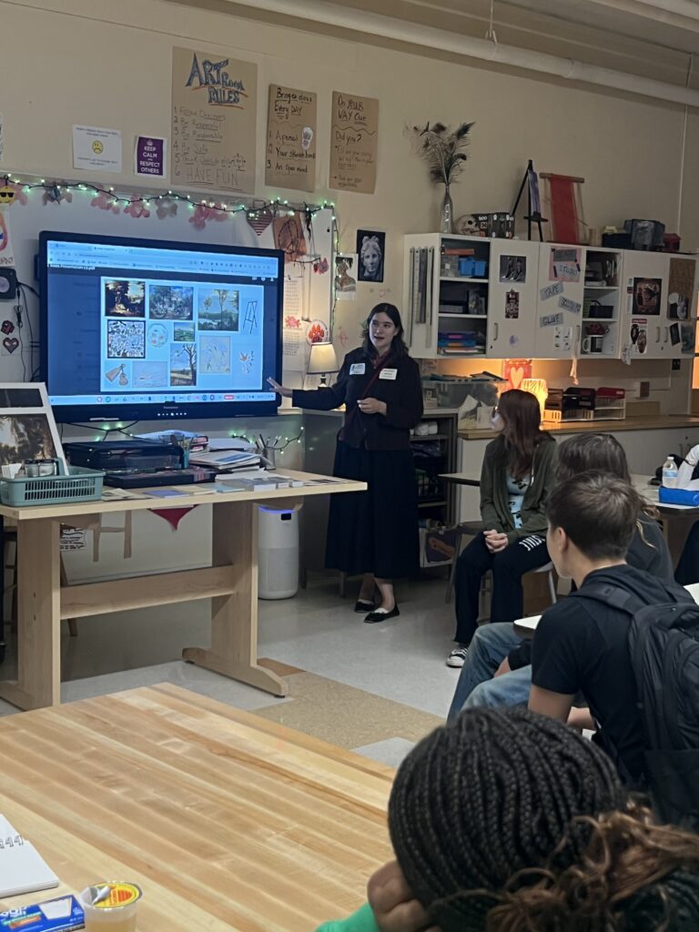 woman leading presentation to art students