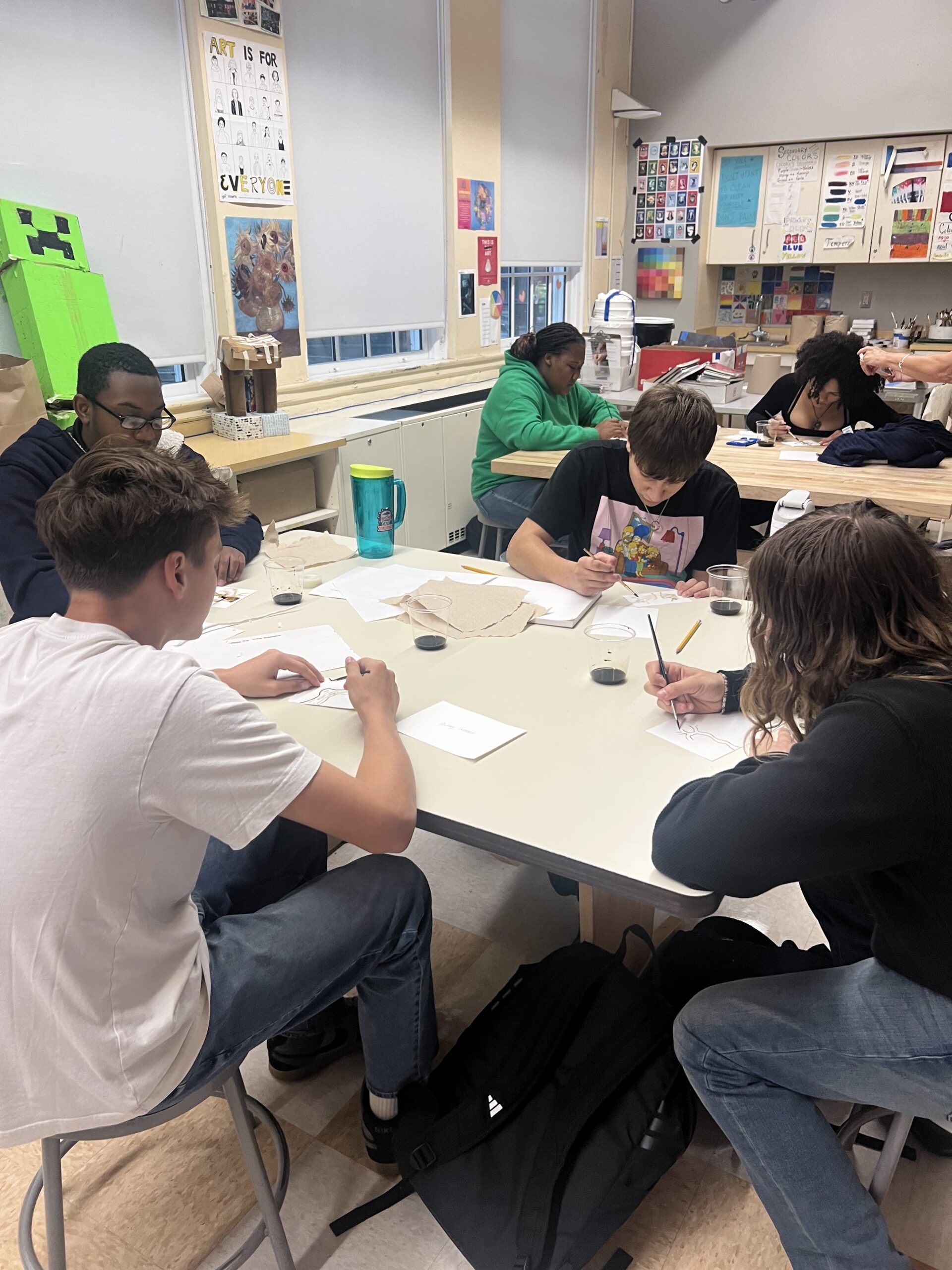 students painting trees
