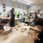 woman leading presentation to art students