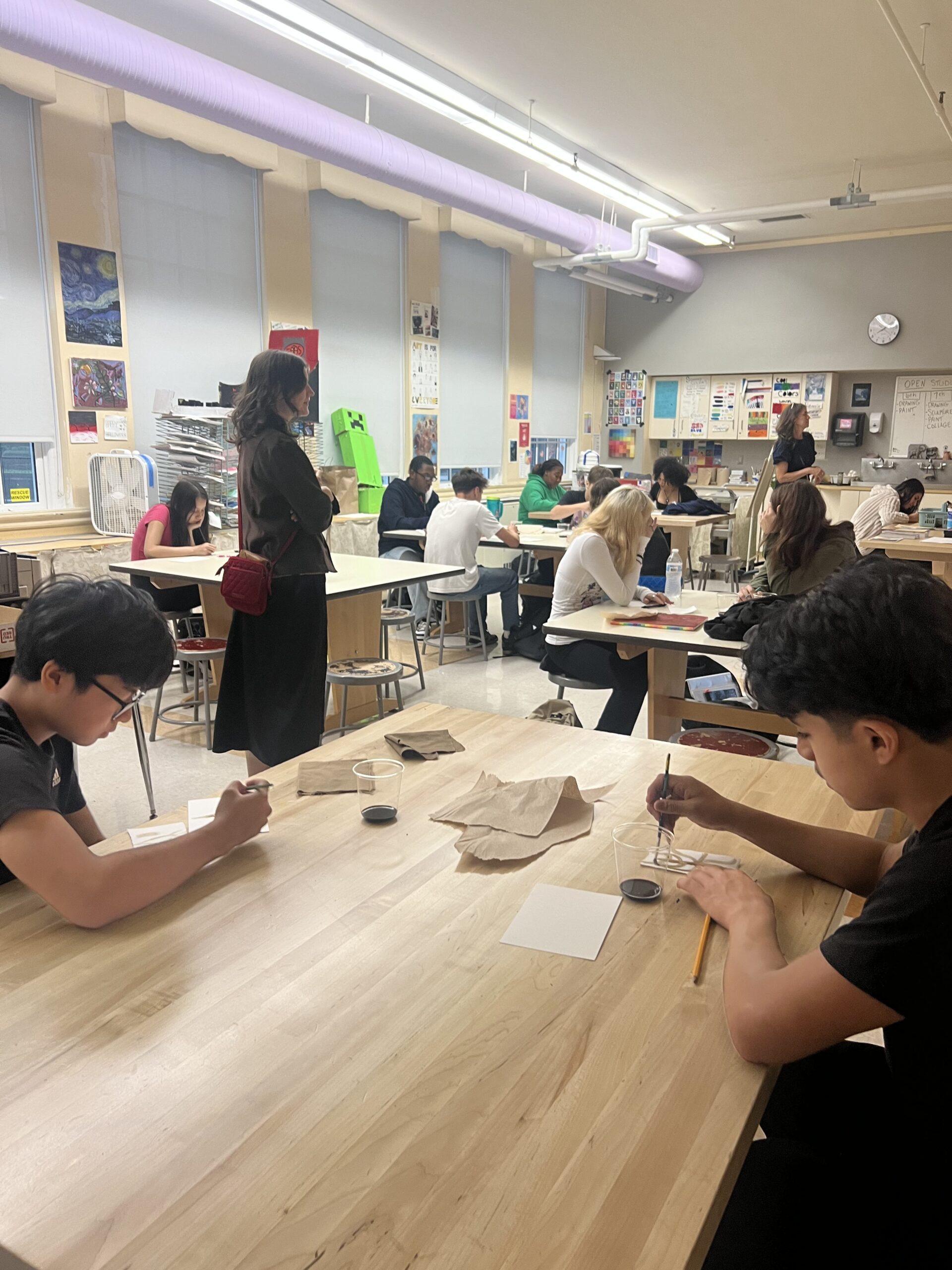 woman leading presentation to art students