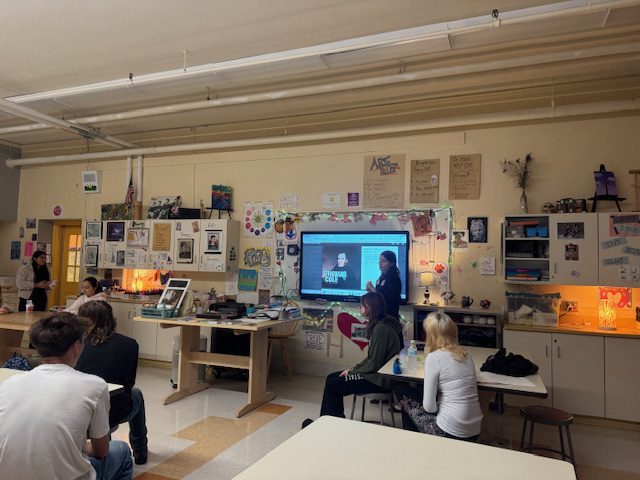 woman leading presentation to art students