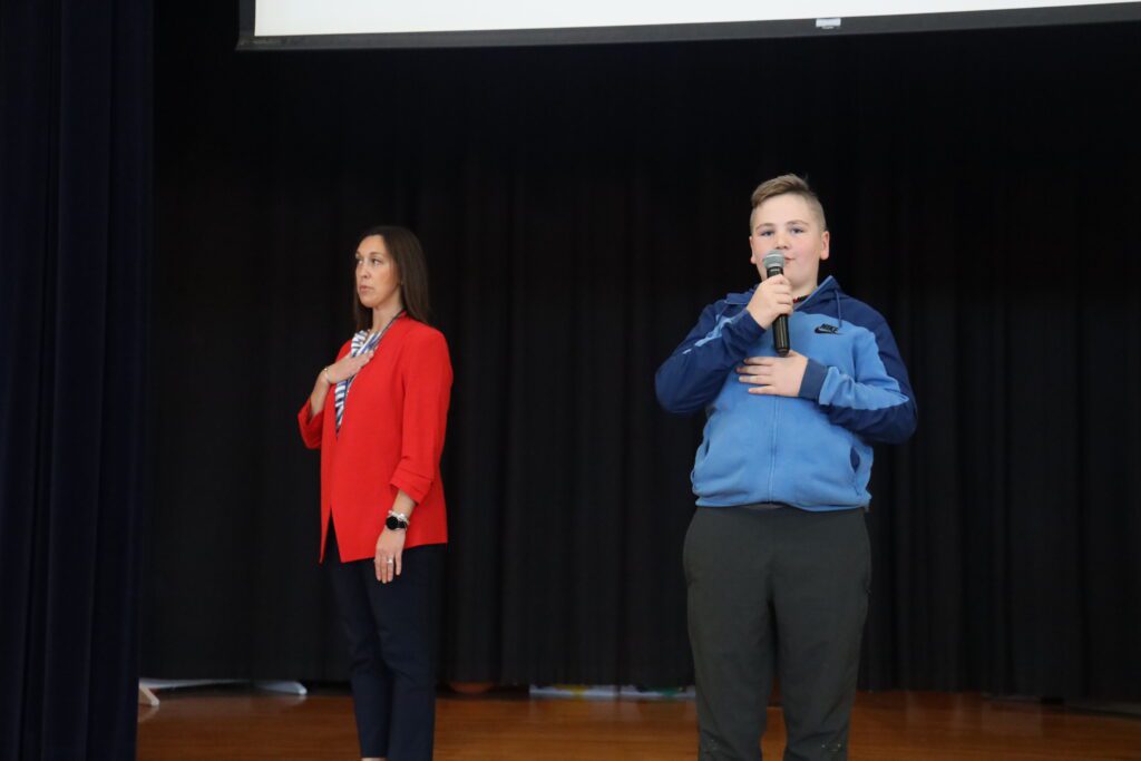 boy and woman reciting the Pledge of Allegiance