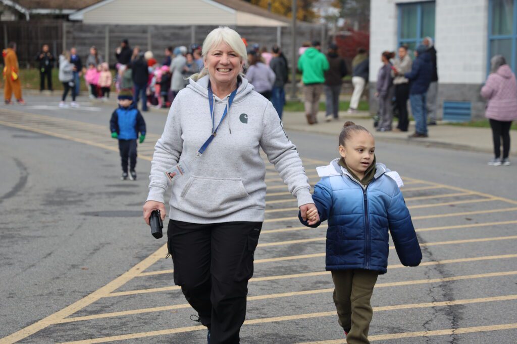 woman holding child's hand