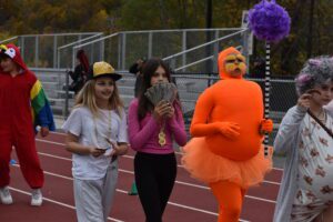 Students parade in costumes on the school track