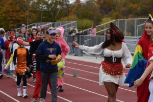 Students parade in costumes on the school track