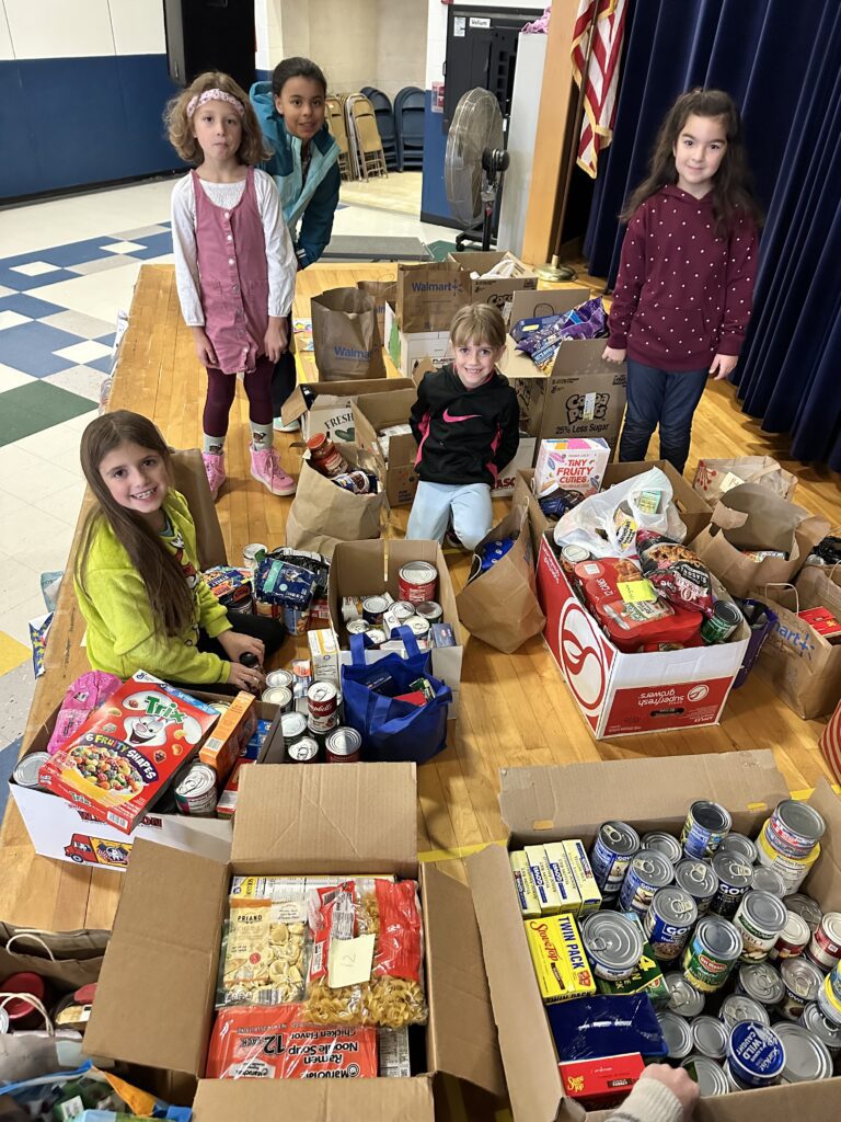 students pose with boxes filled with groceries