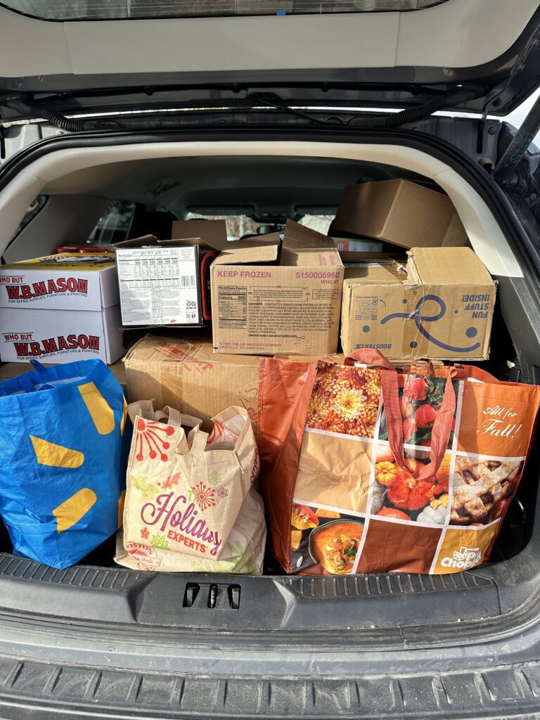 trunk of car stuffed with groceries