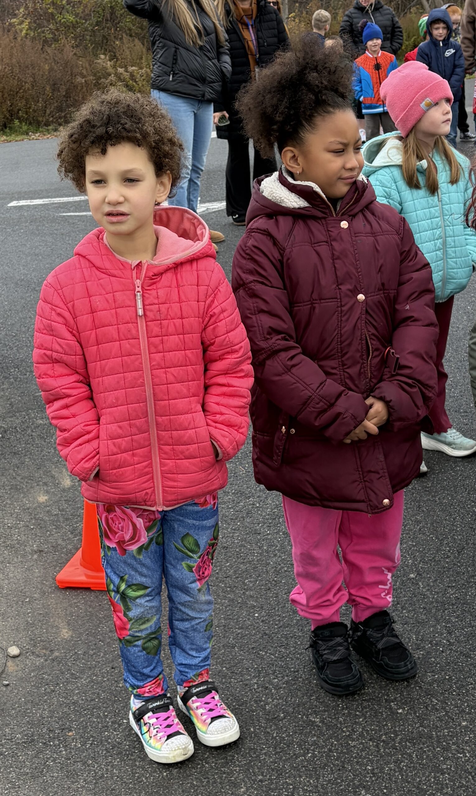 two girls standing outside