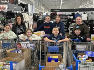 CES Student Council posing for group photo in grocery store.