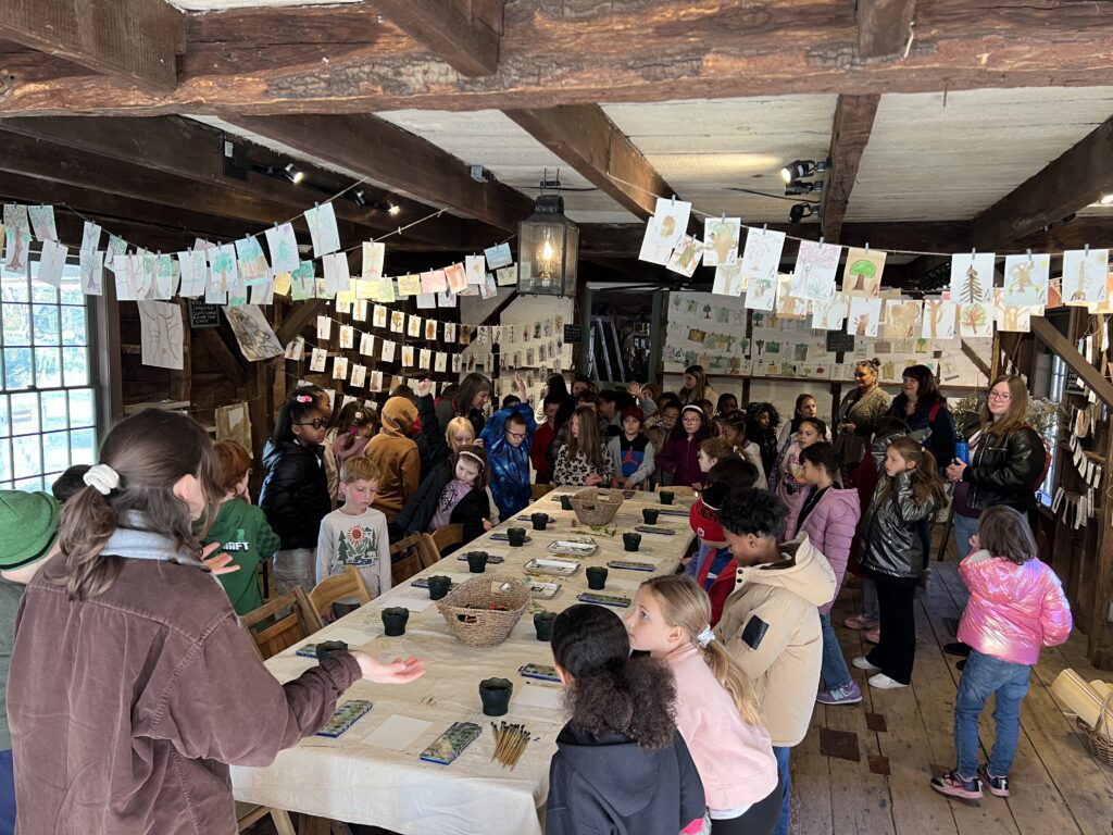 students creating art at table in museum