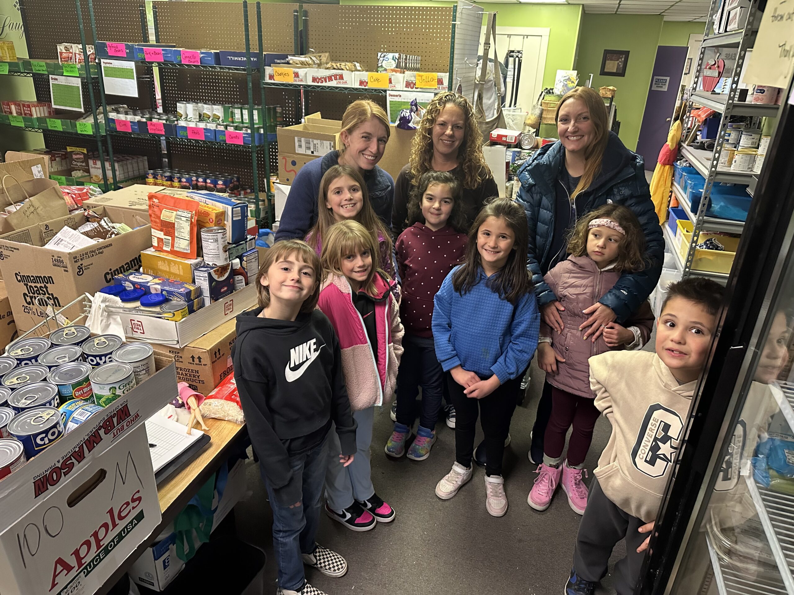 students pose with groceries