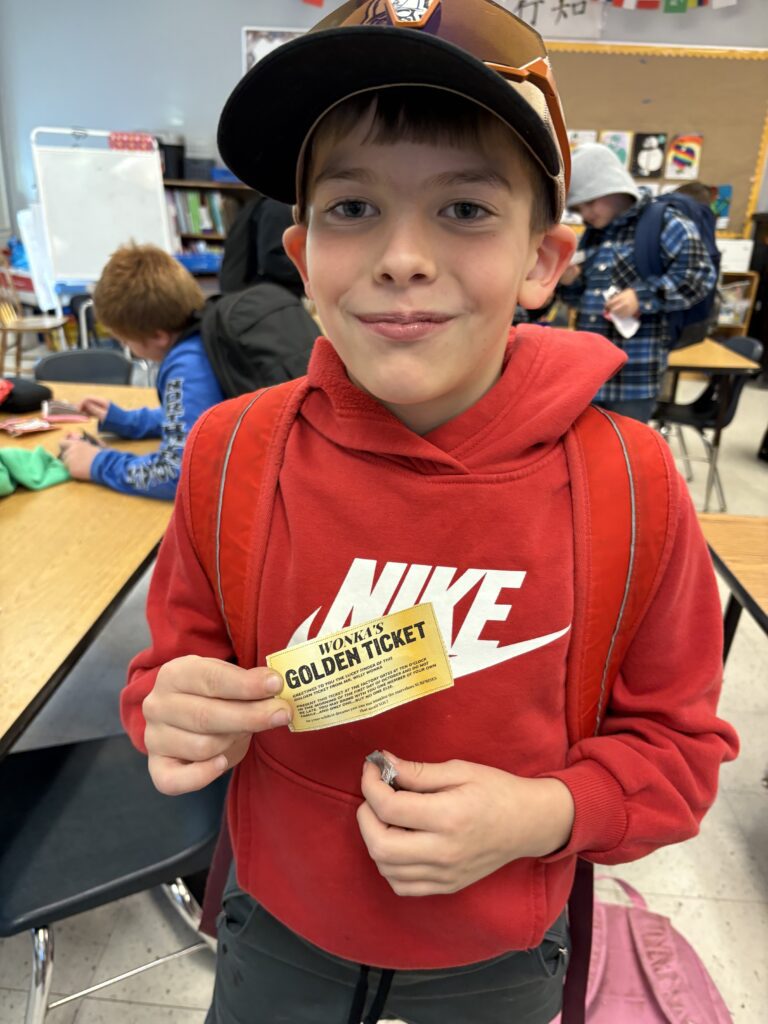 boy holding golden ticket