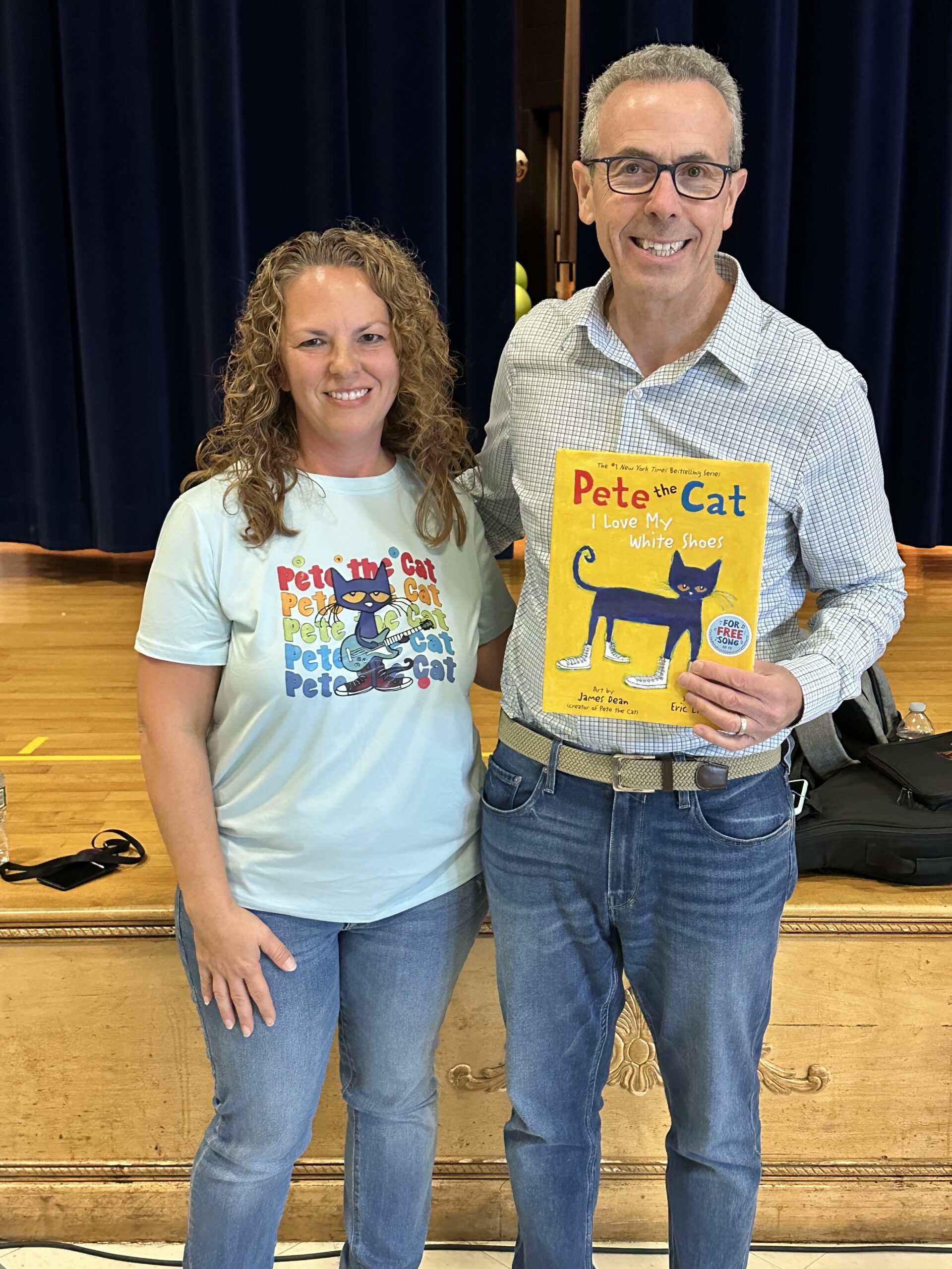 woman and man poses with Pete the Cat book