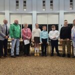 student council officers and advisor poses with Board and administration members