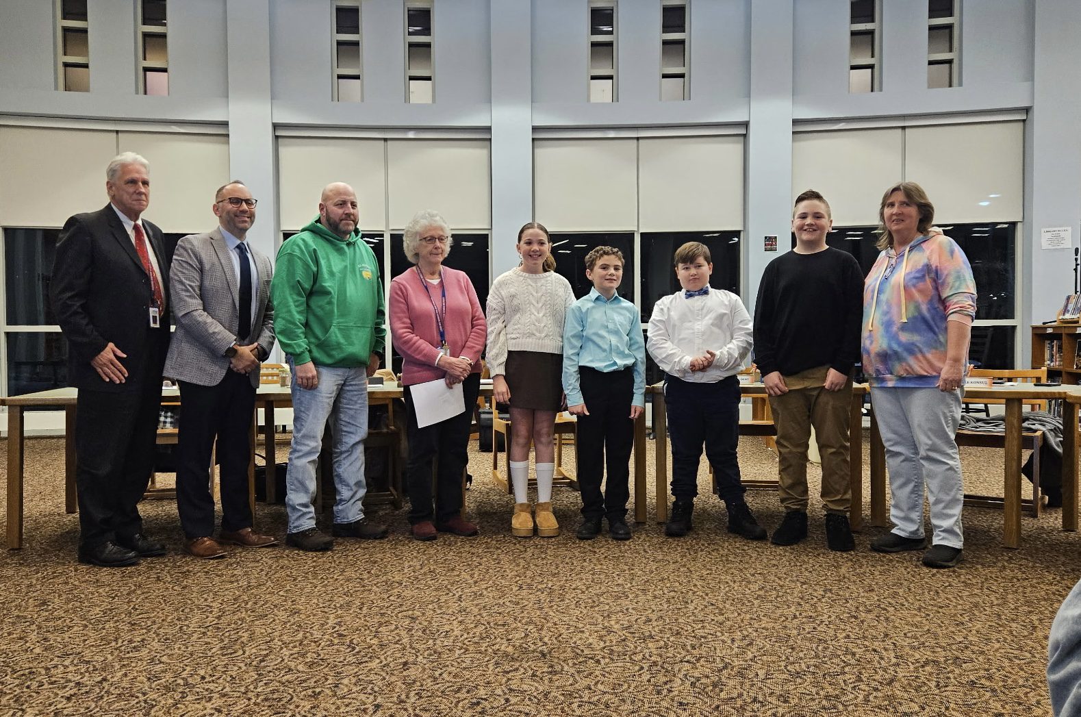 student council officers and advisor poses with Board and administration members