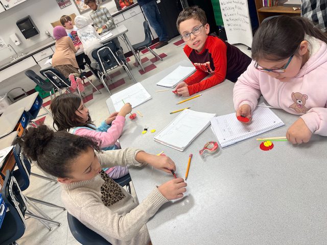 students designing miniature wheeled cart