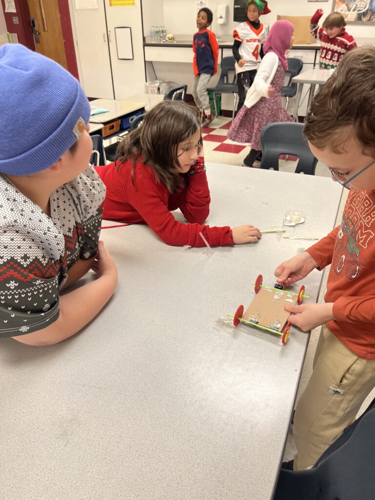 students designing miniature wheeled cart