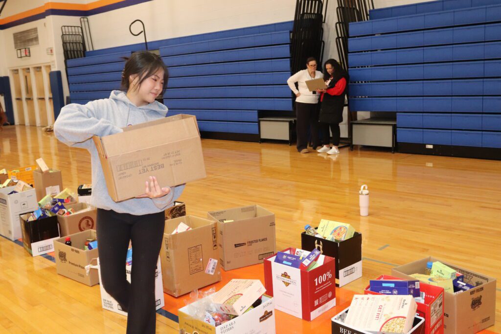 teenage girl packing food in box