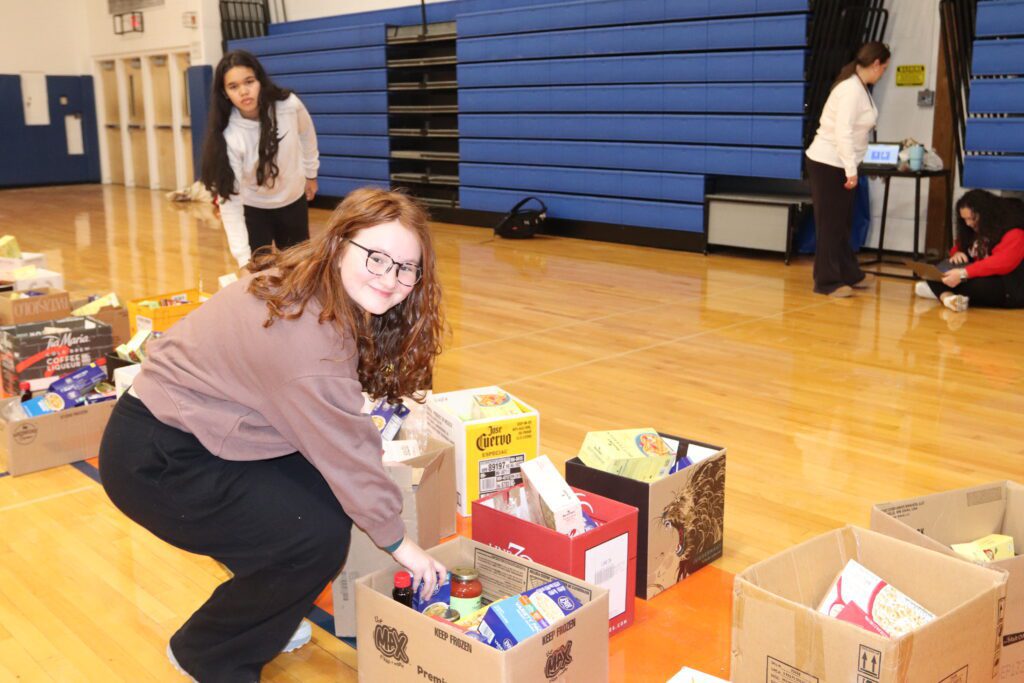 teenage girl packing food in box