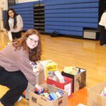 teenage girl packing food in box