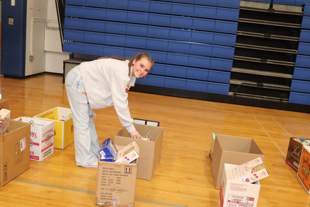 teenage girl packing food in box