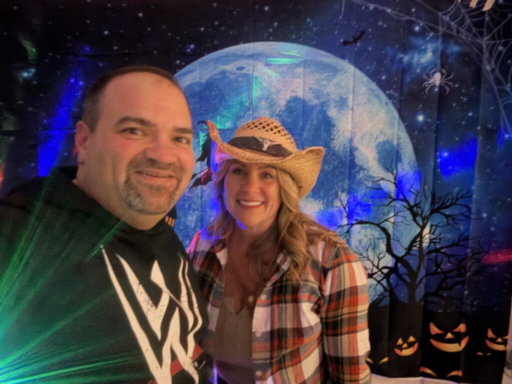 man and woman wearing cowboy hat pose in from of Moon image