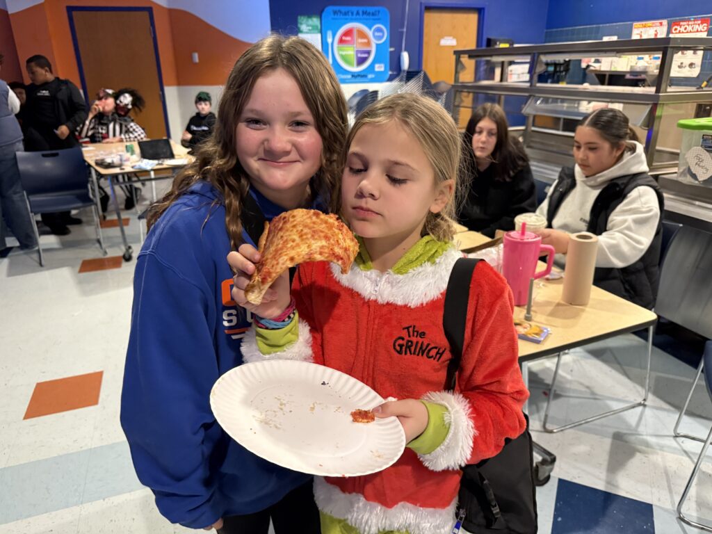 two girls with pizza