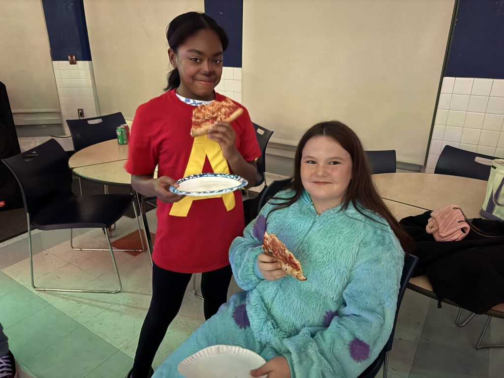 two girls eating pizza