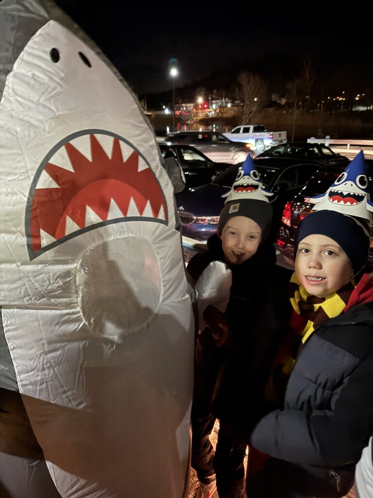 two boys and big shark costume