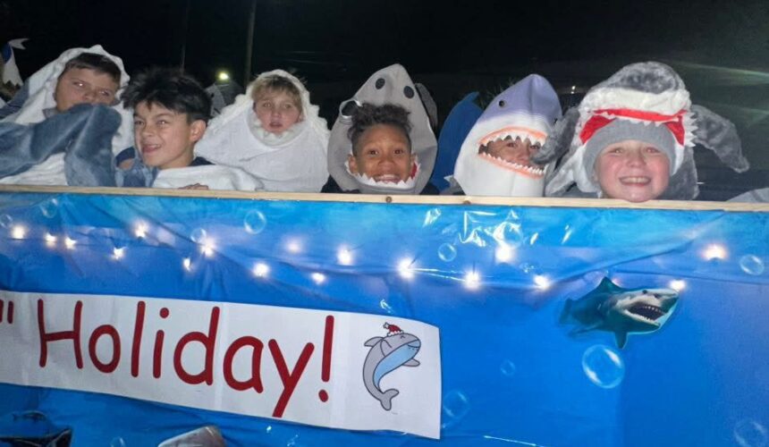 IMG_9841 parade float with students dressed as sharks on it