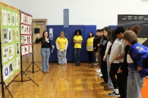 students looking at quilts