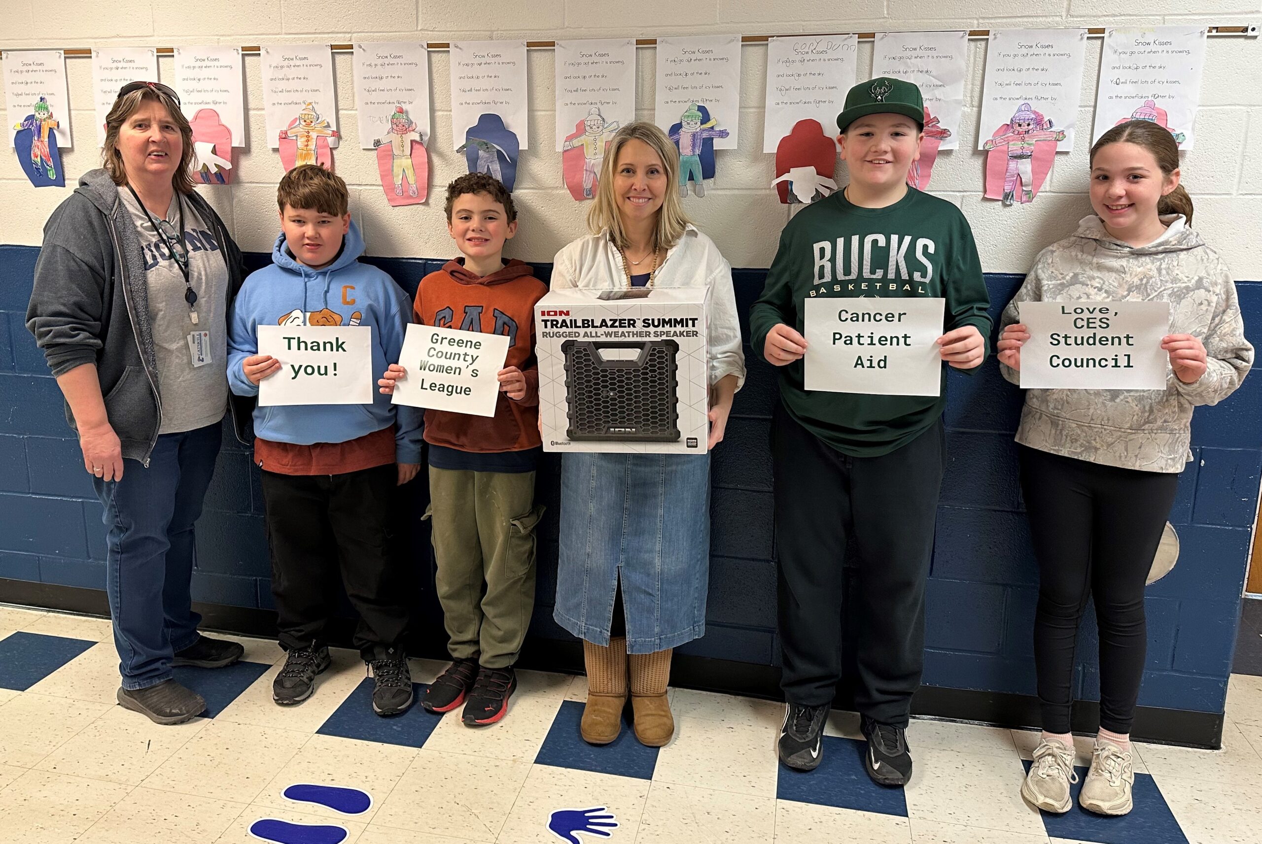 students and teachers holding notes and large travel speaker