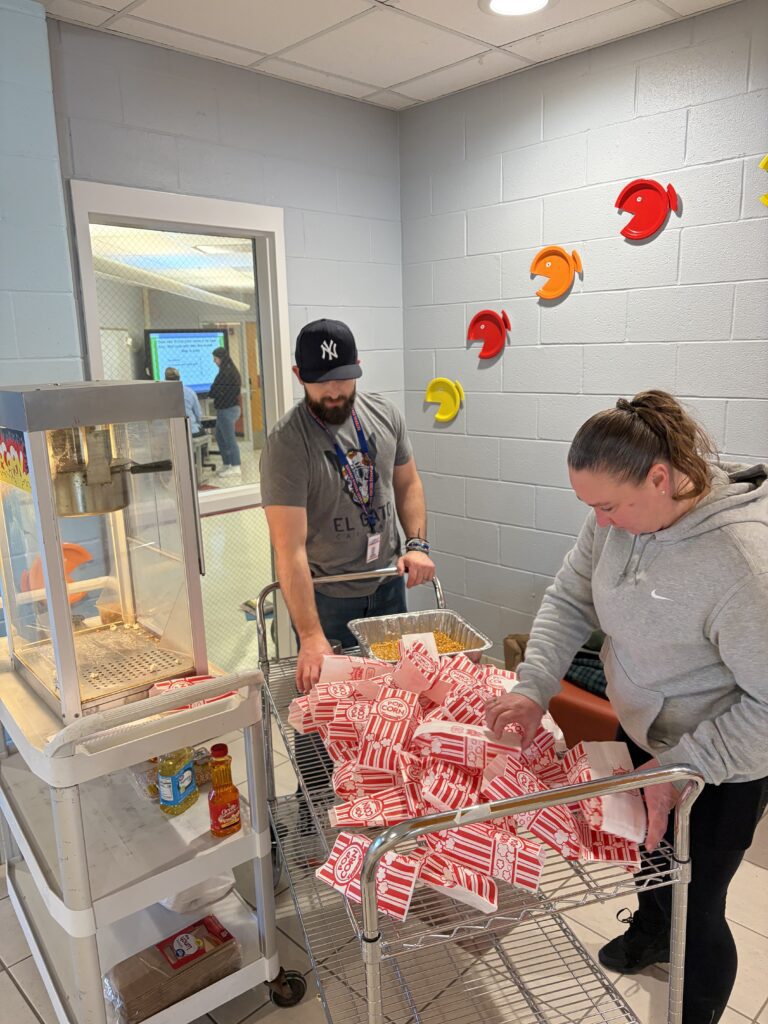 man and woman bagging popcorn