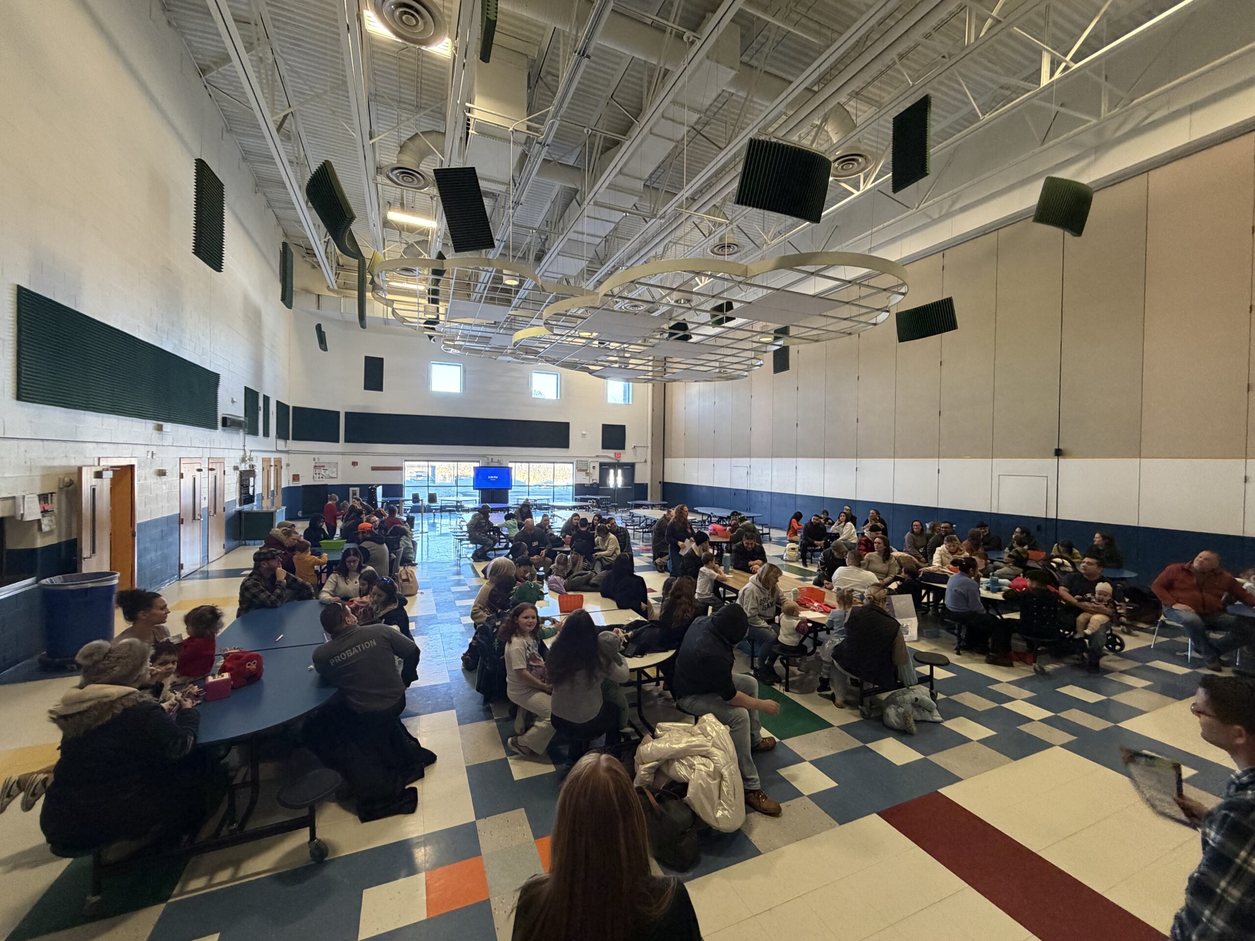 people sitting at cafeteria tables