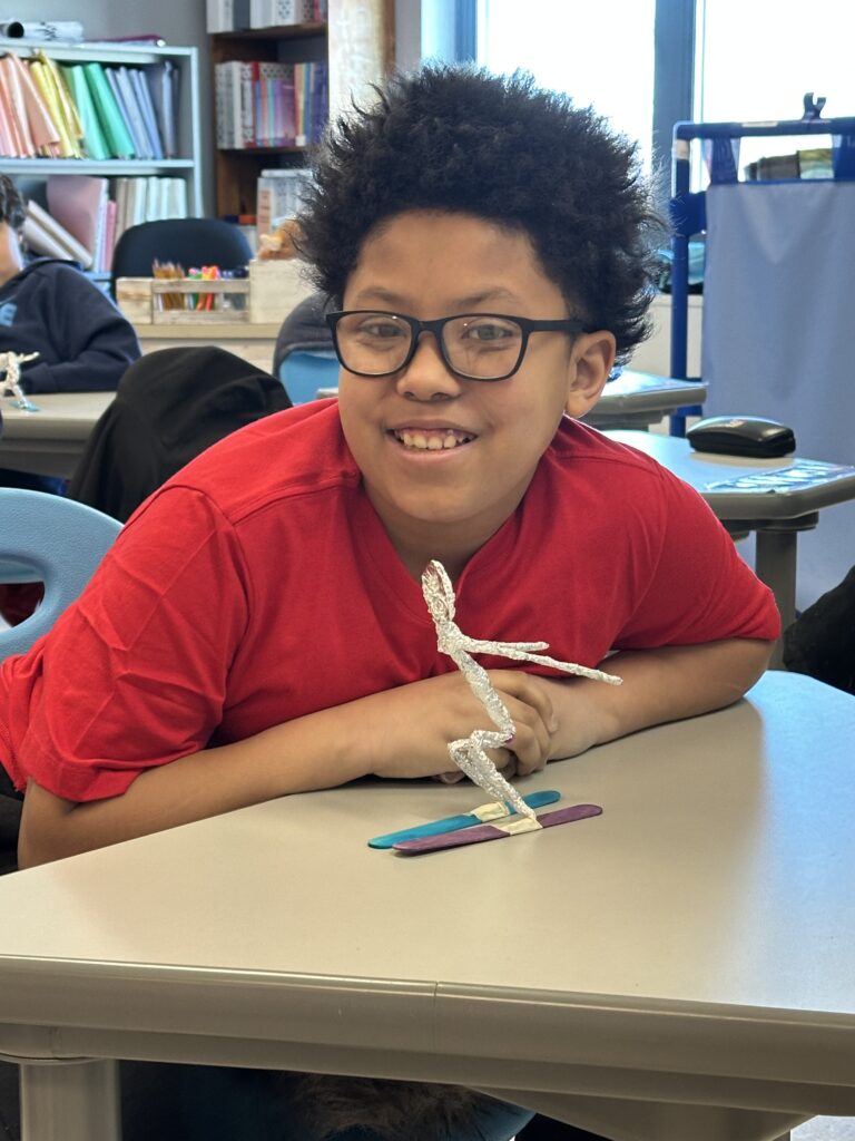 student posing with skier model