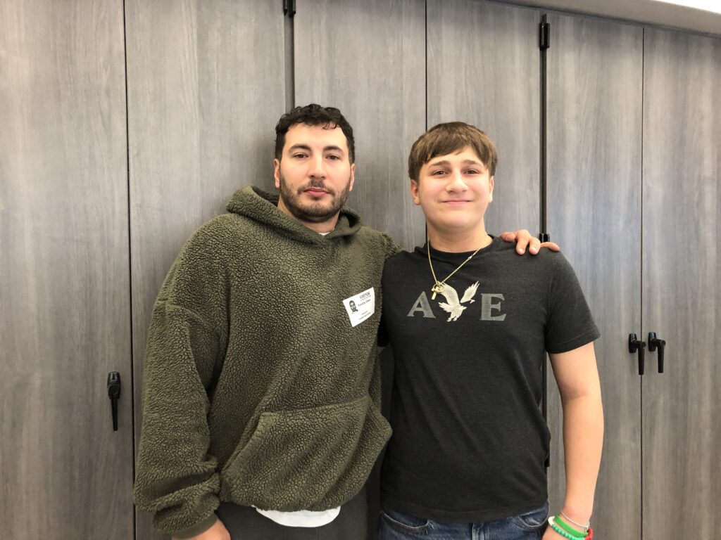 man and young man posing for picture