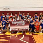 Boys volleyball team holding Section 2 Championship banner