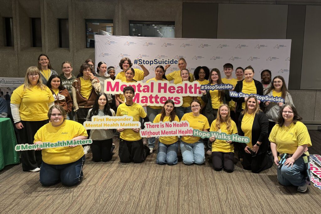 student wearing yellow shirts posing for photo
