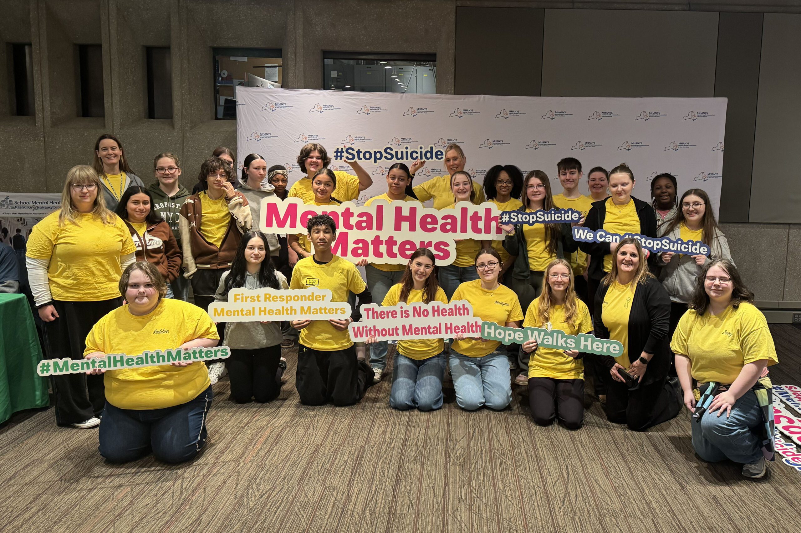 student wearing yellow shirts posing for photo