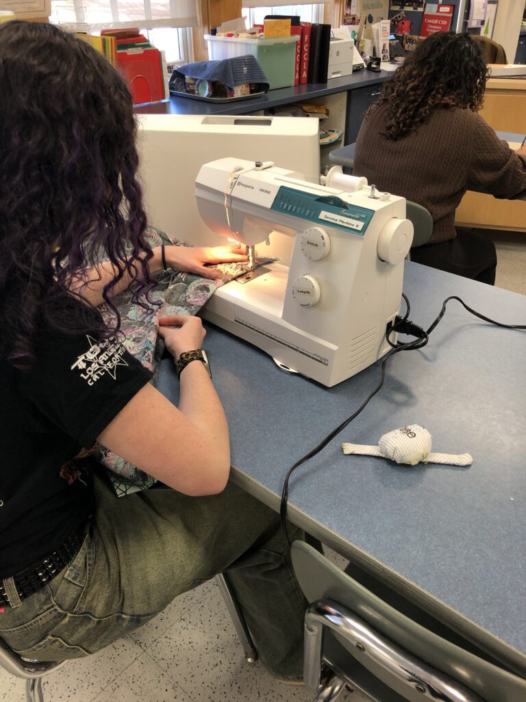 girl using sewing machine